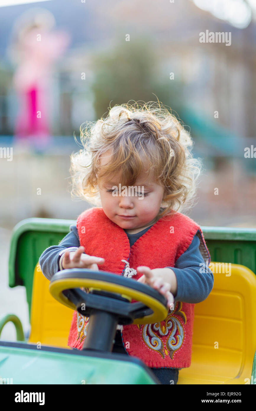 Caucasian baby boy driving toy tractor Stock Photo