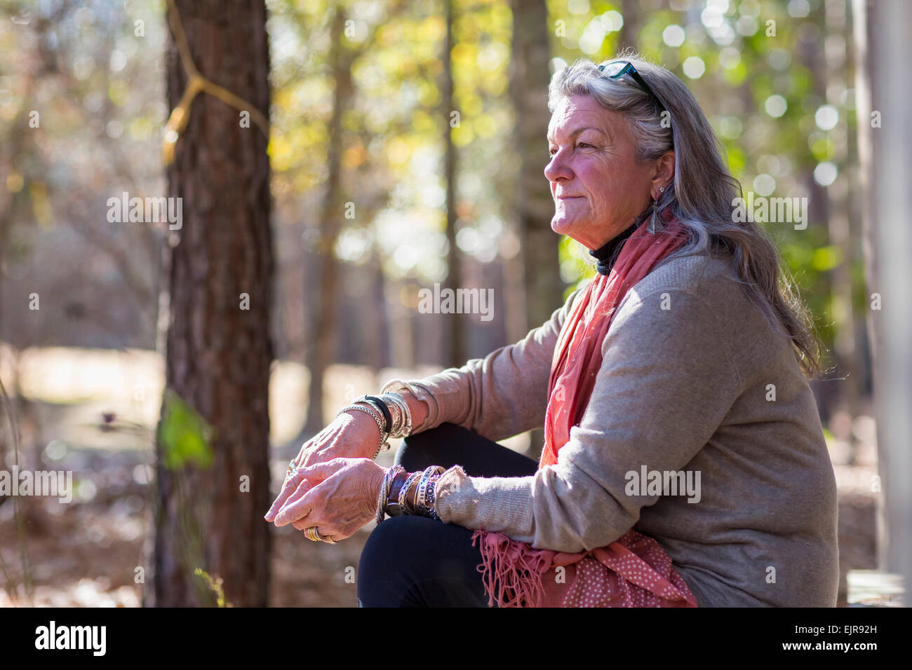 Older Caucasian woman sitting outdoors Stock Photo