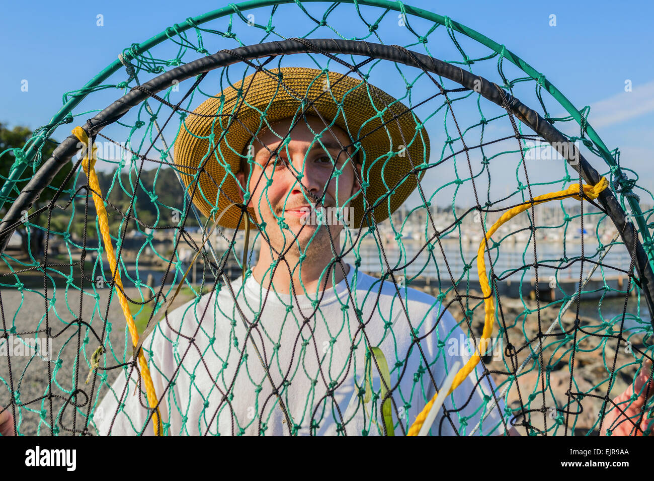 Caucasian man holding fishing net Stock Photo