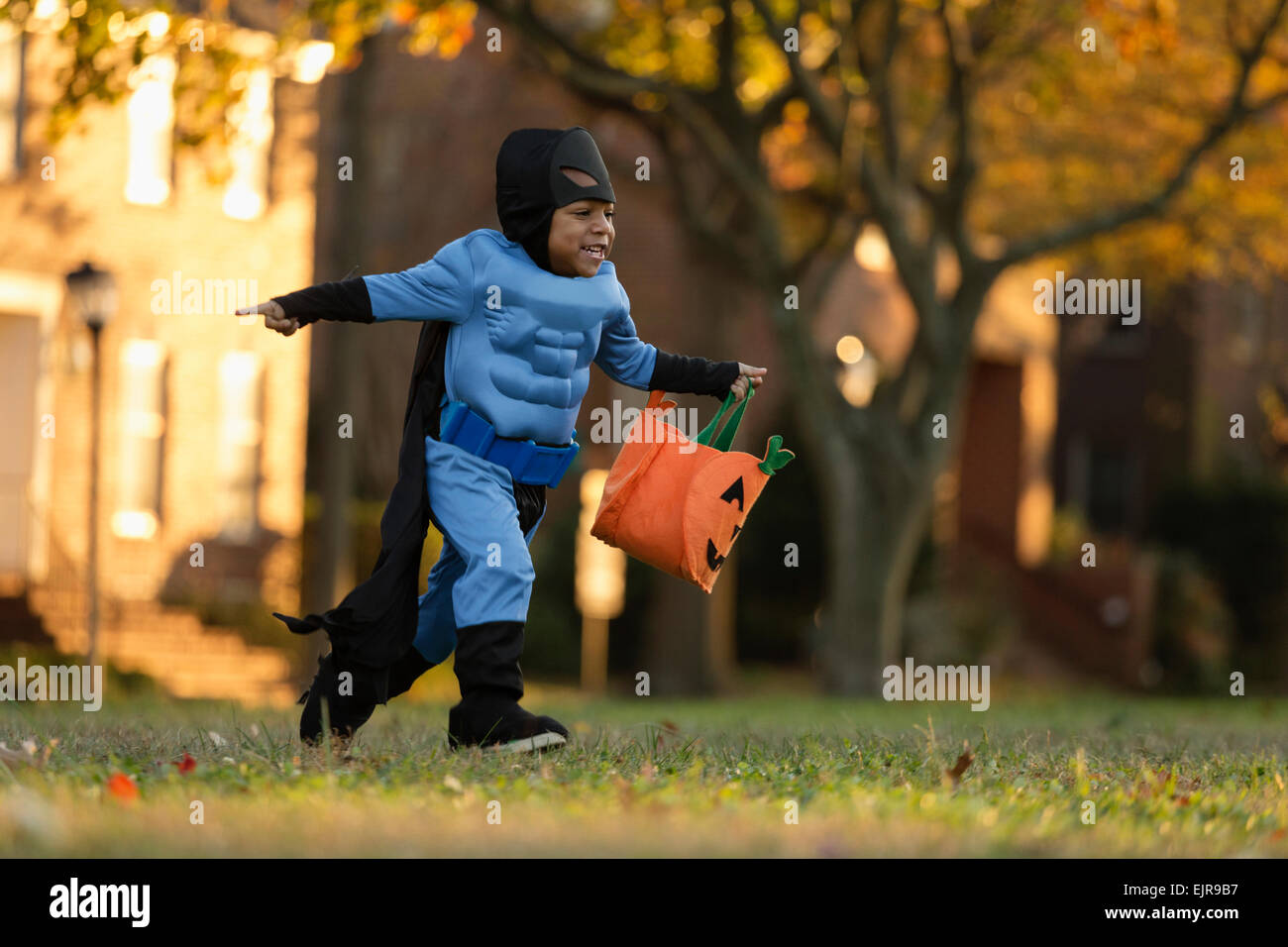 African American boy trick-or-treating on Halloween Stock Photo
