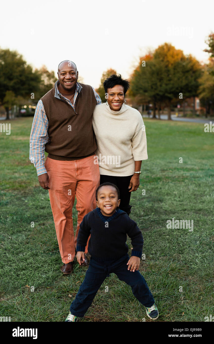 African American family smiling in park Stock Photo