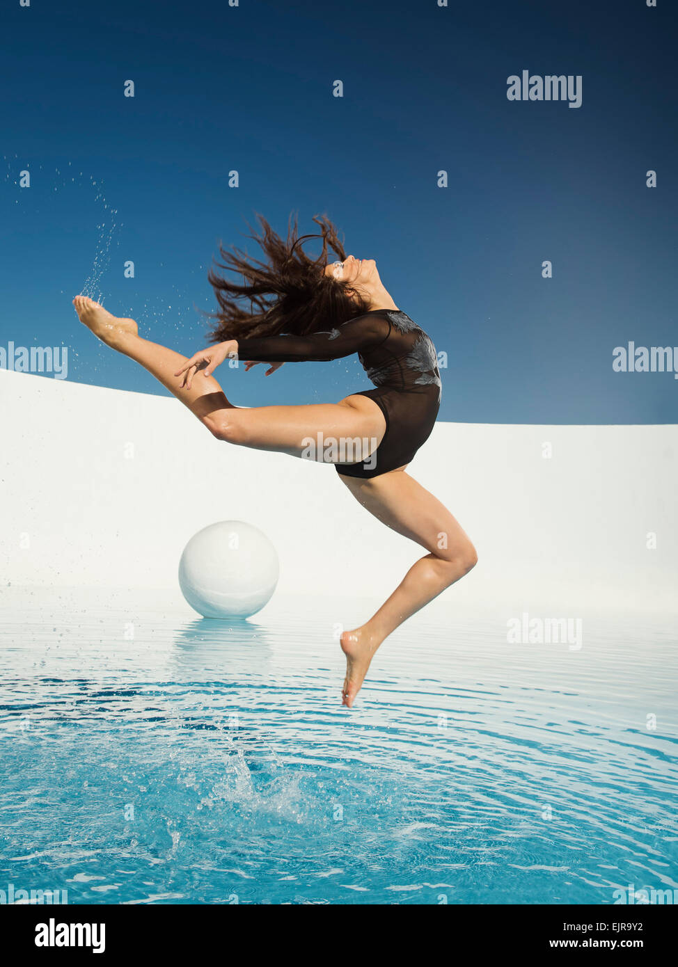 Caucasian woman dancing on water surface Stock Photo