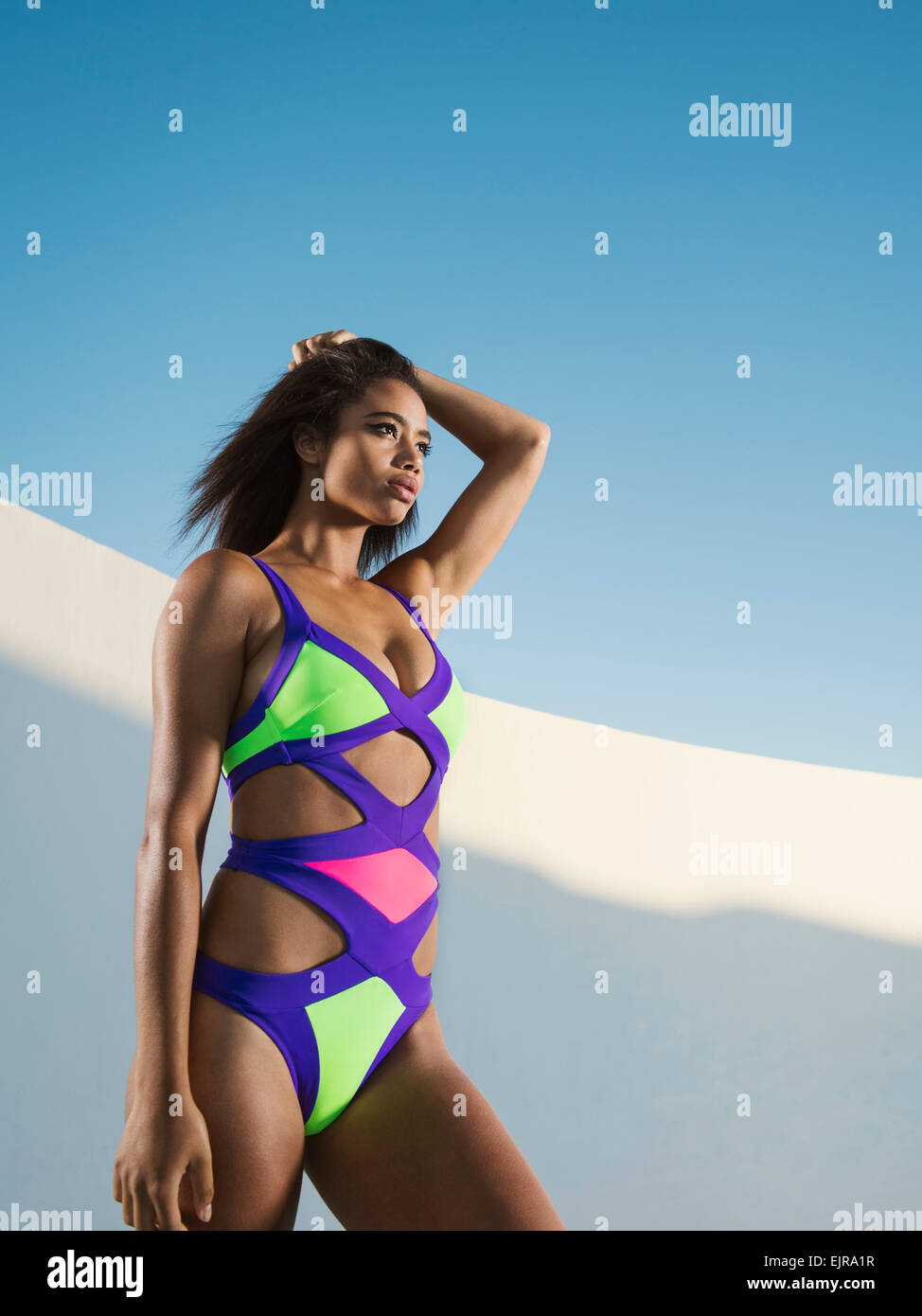 Mixed race woman wearing colorful swimsuit Stock Photo