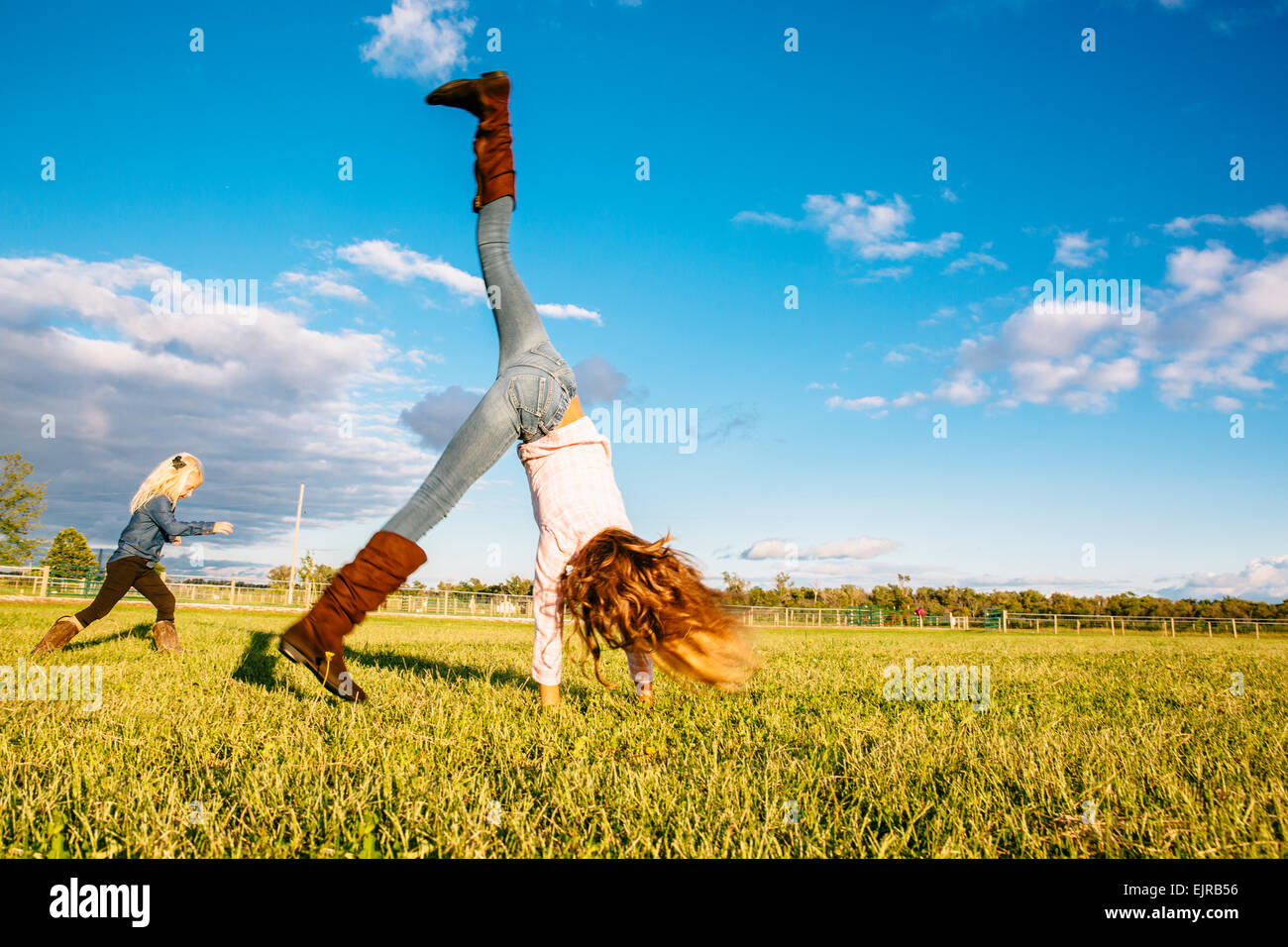 Caucasian girls playing in rural field Stock Photo - Alamy