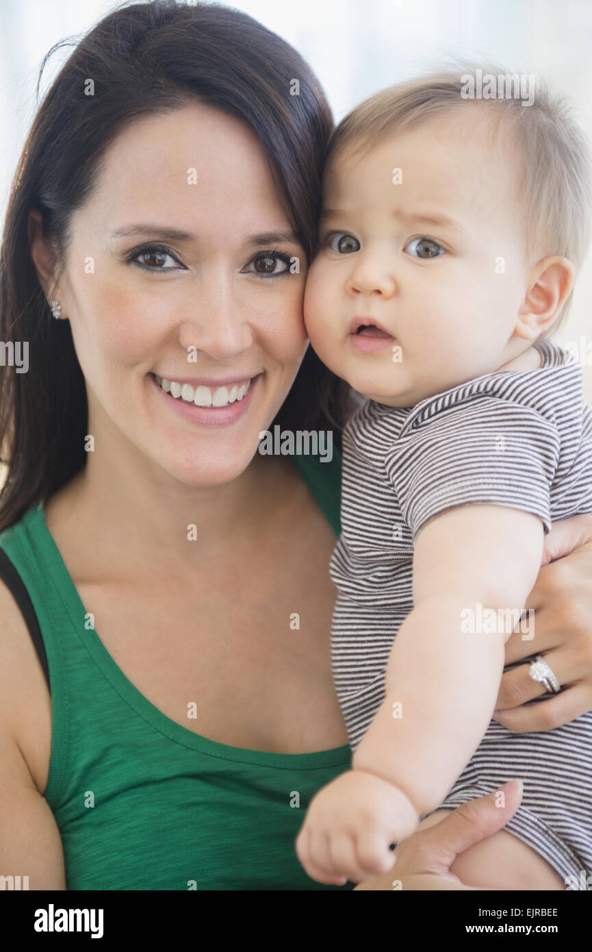 Mixed race mother holding baby Stock Photo