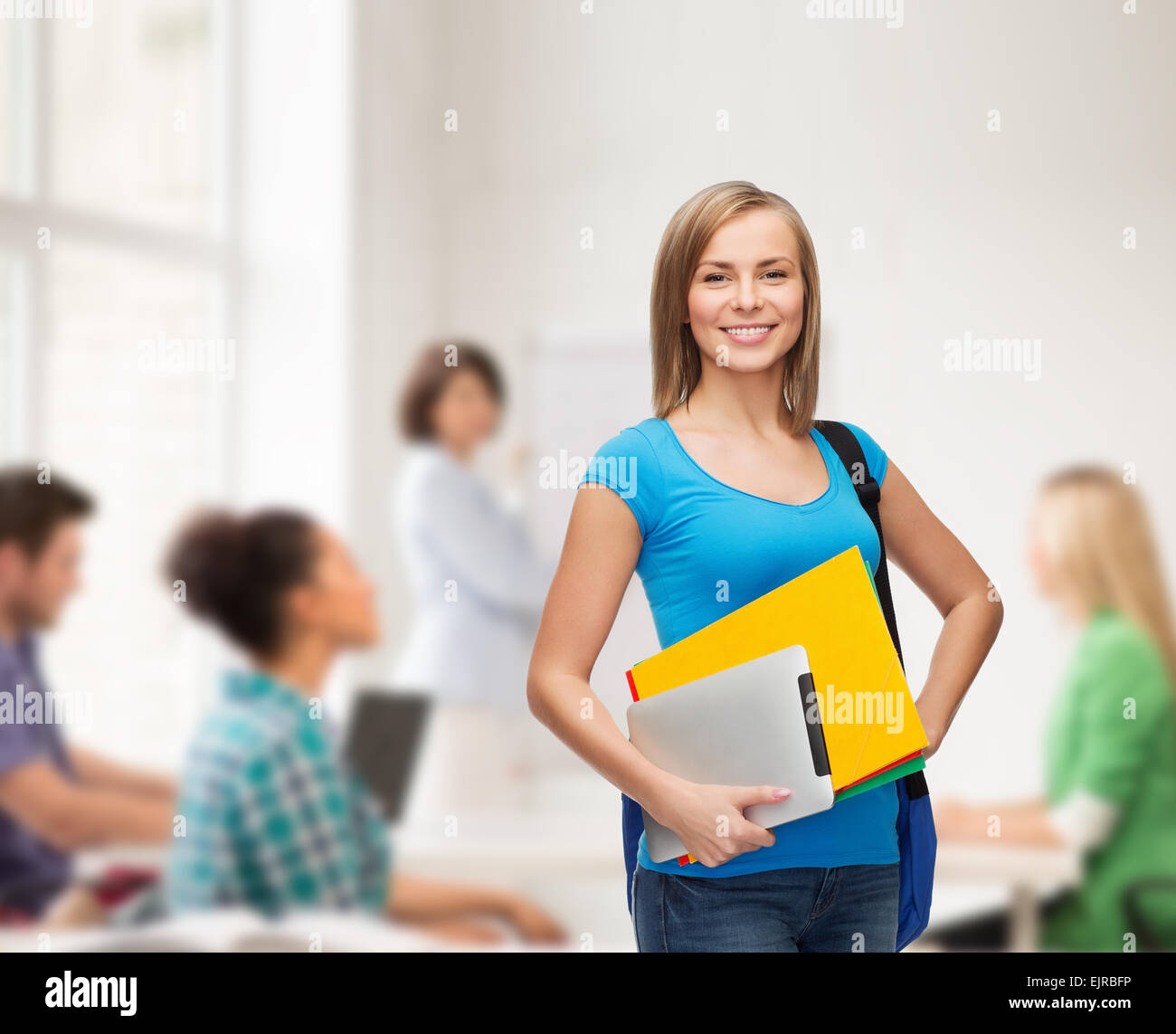 smiling student with bag, folders and tablet pc Stock Photo - Alamy