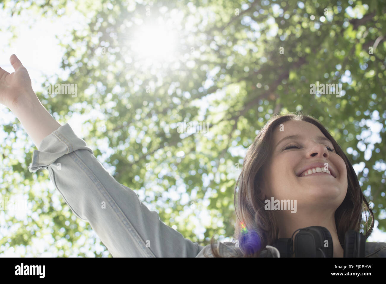 Low angle view of Caucasian woman cheering outdoors Stock Photo