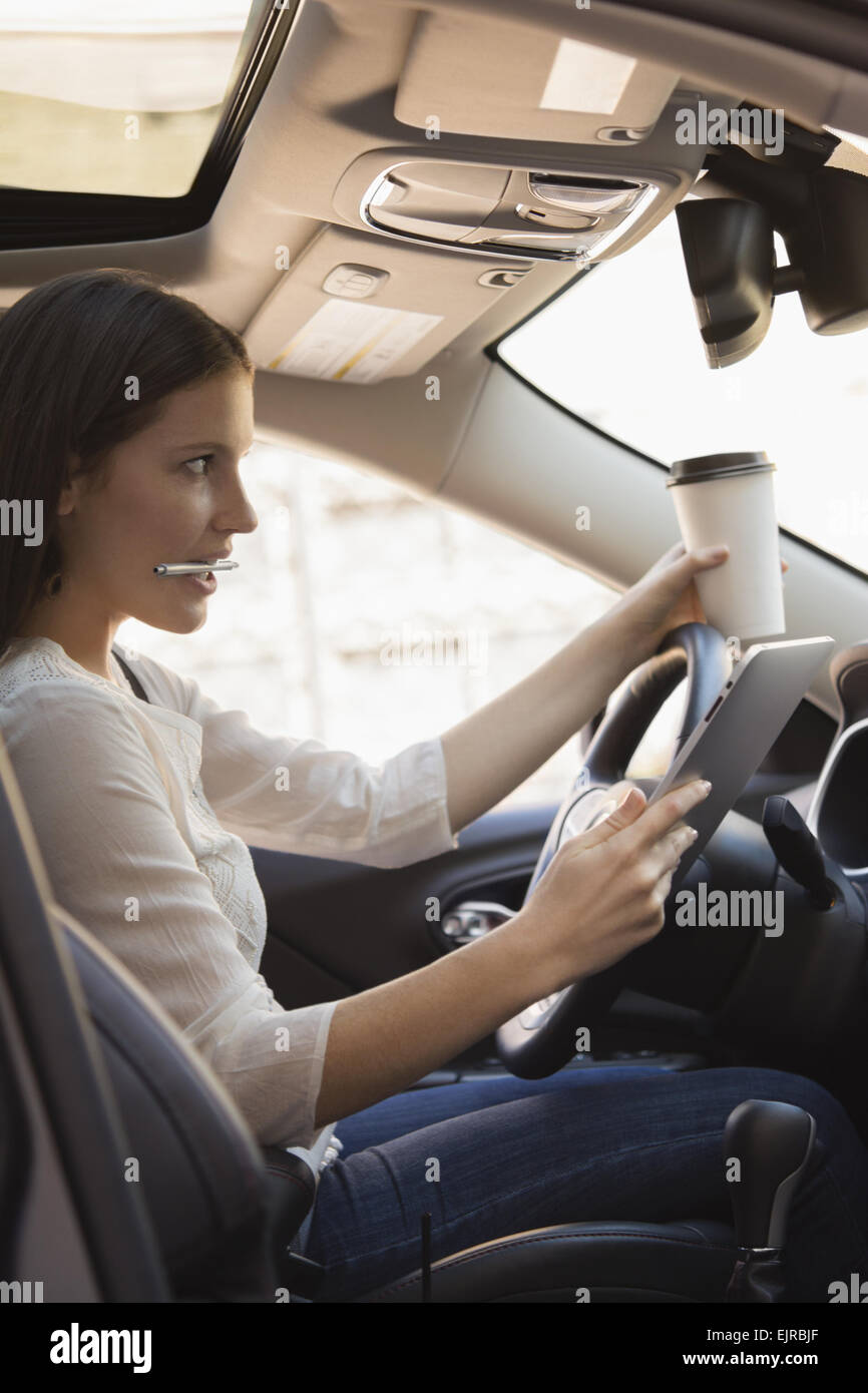 Woman sitting in a car and playing a Pokemon Go game Stock Photo - Alamy