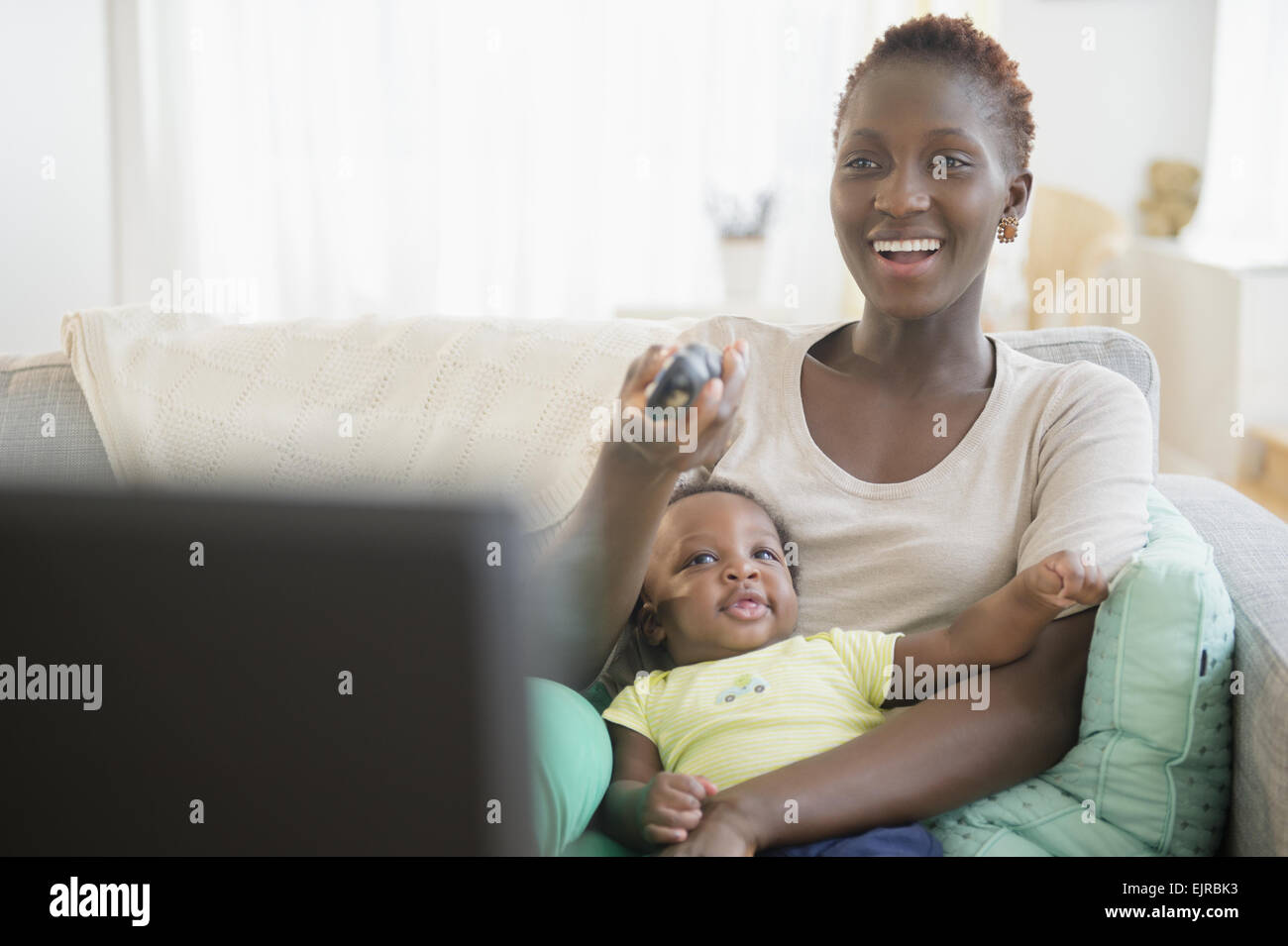 Black mother and son playing on sofa Stock Photo