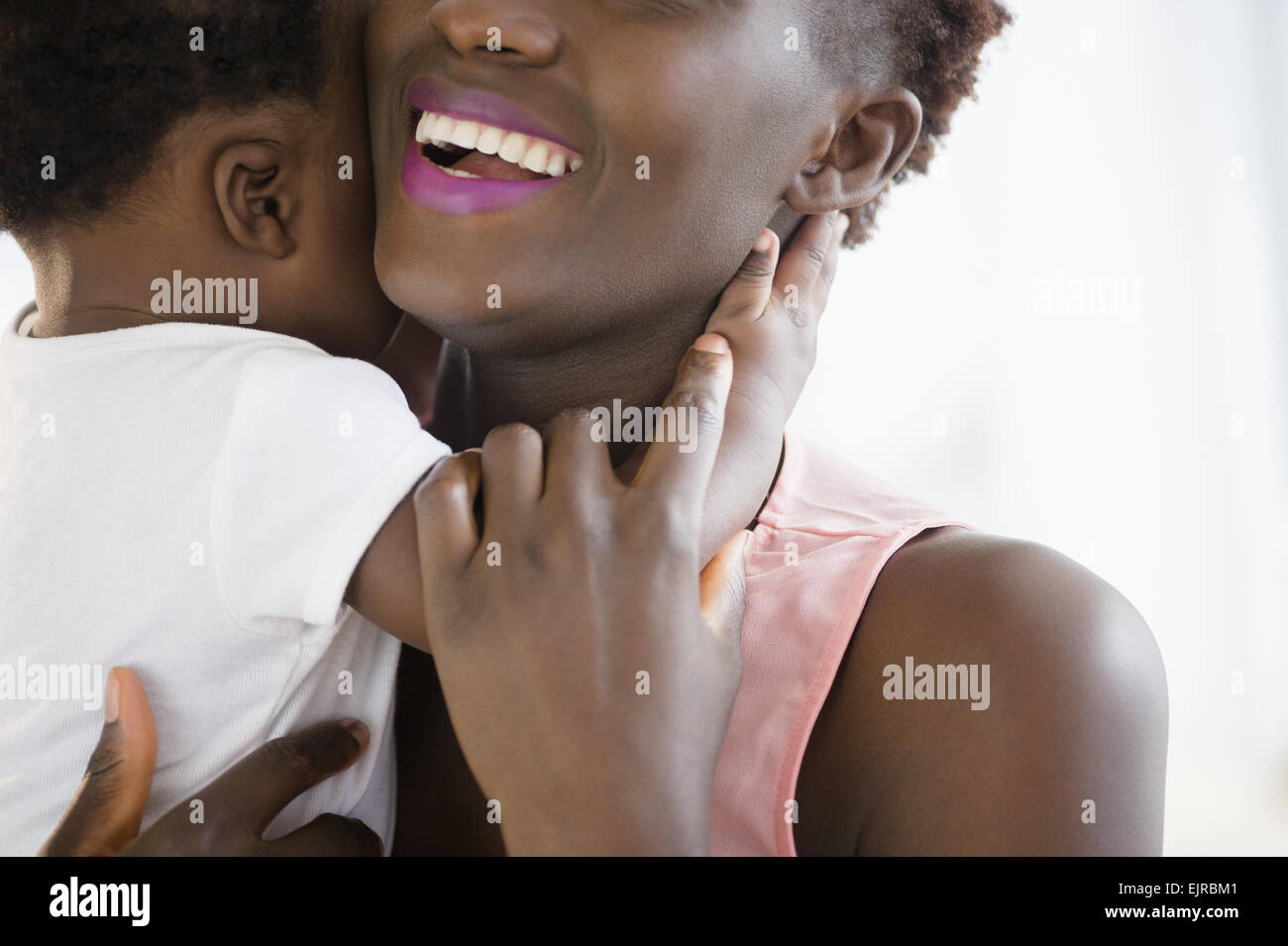 Close up of Black mother holding son Stock Photo