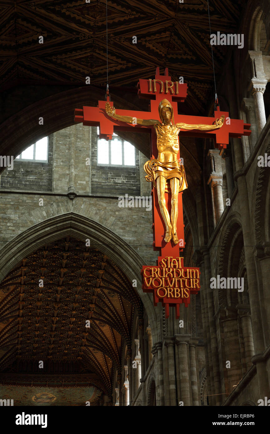 The hanging crucifix in Peterborough Cathedral, England. The gilded sculpture dates from 1975. Stock Photo