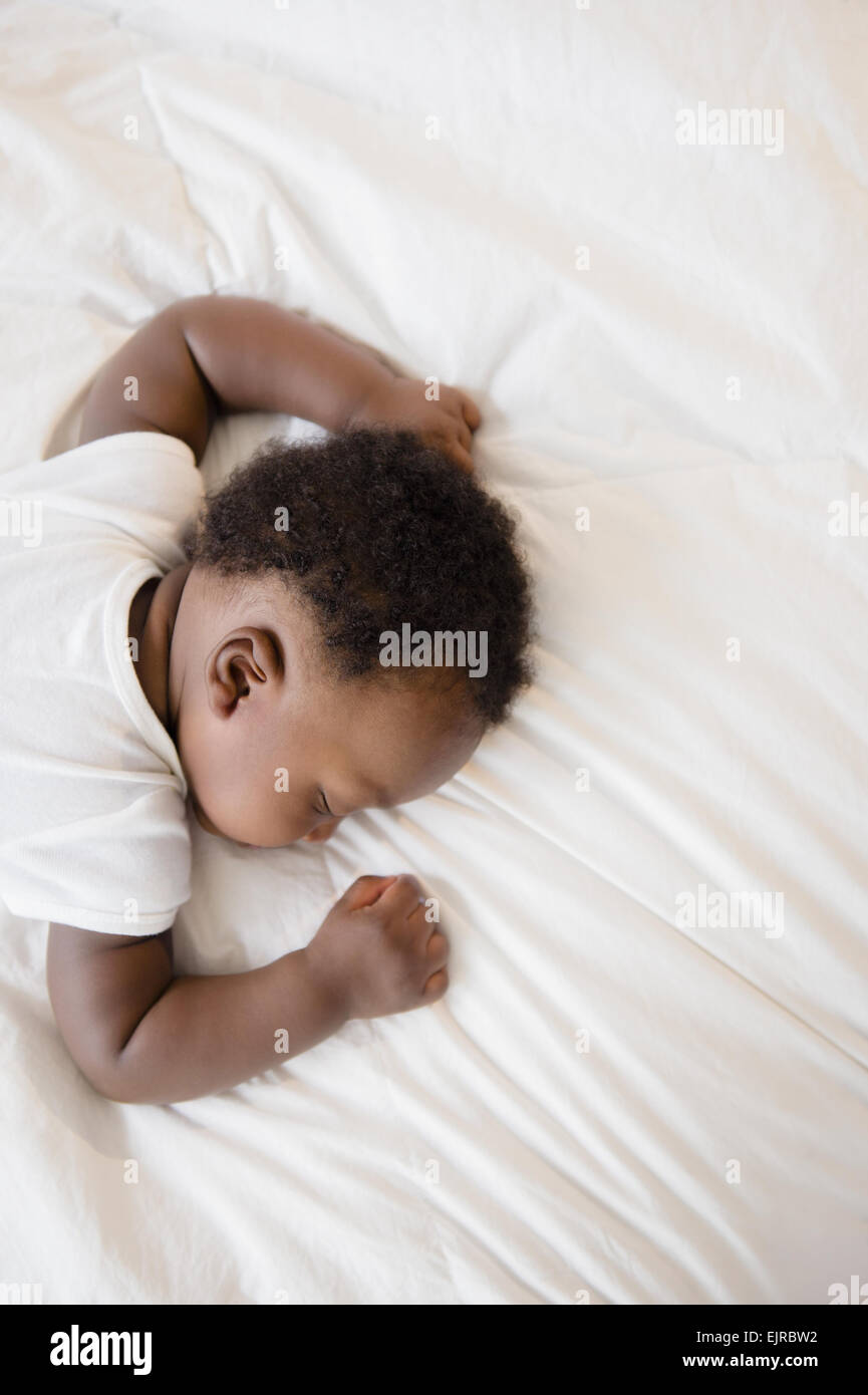 Overhead view of Black baby boy sleeping on bed Stock Photo