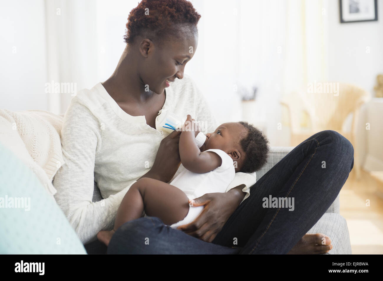 Close up of Black mother feeding baby boy Stock Photo