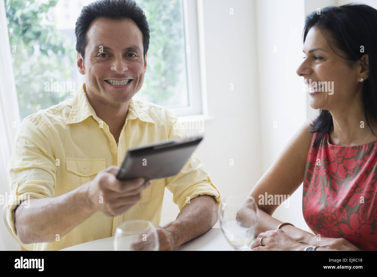 Couple paying check in restaurant Stock Photo