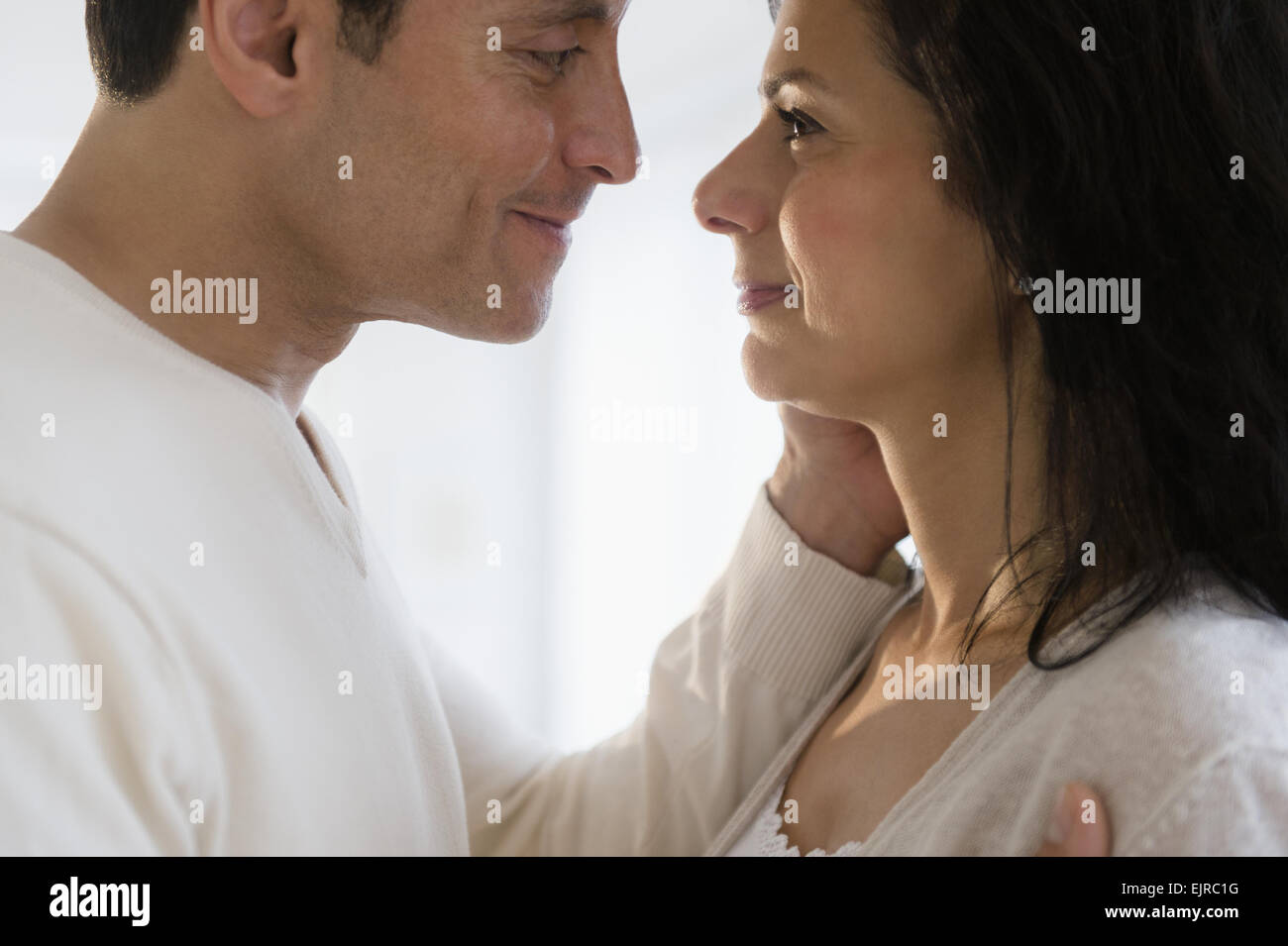 Close up of man holding face of wife Stock Photo