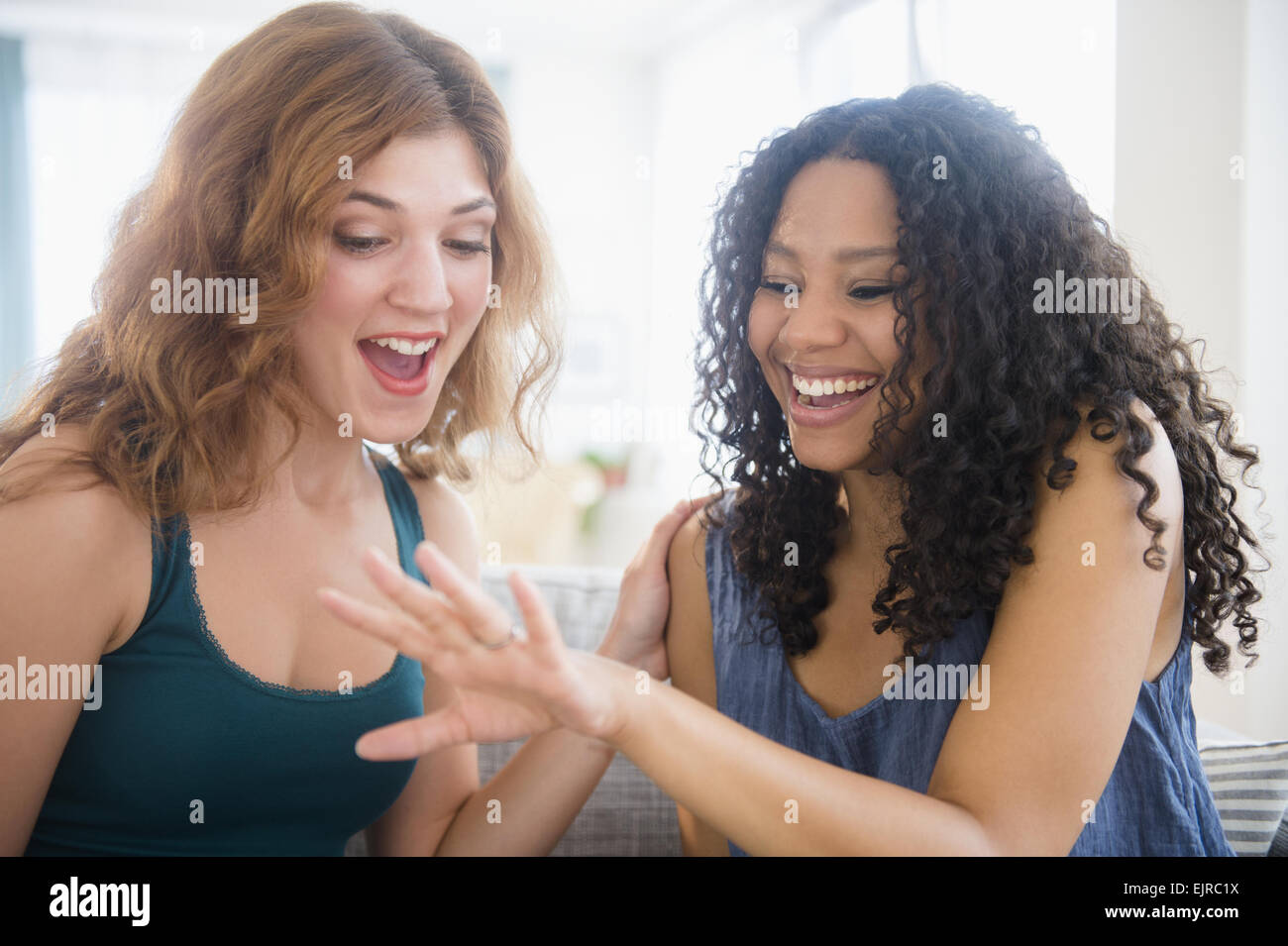 Woman admiring engagement ring of friend Stock Photo