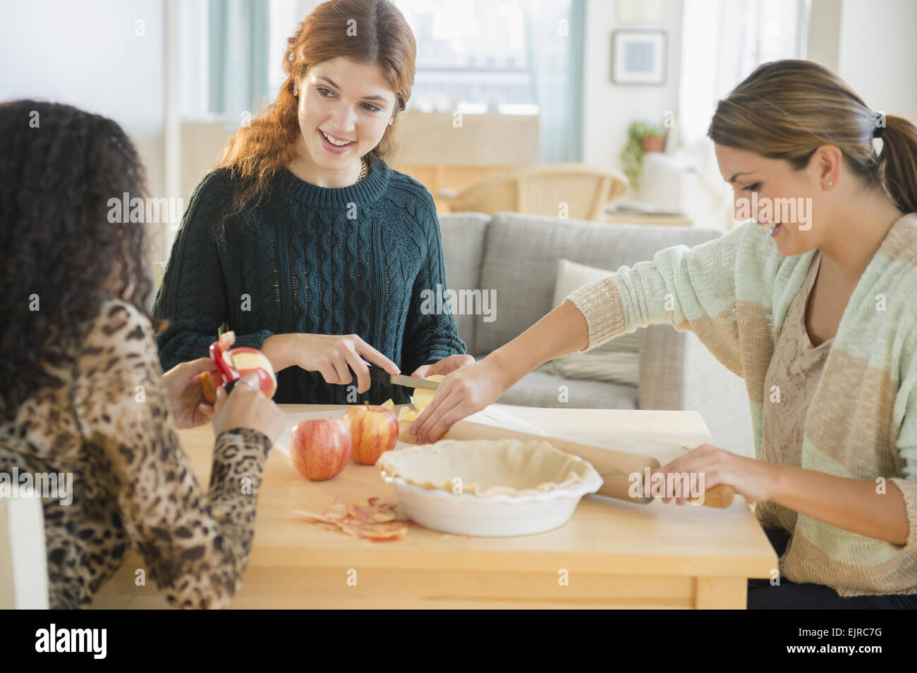Women baking pie in kitchen Stock Photo