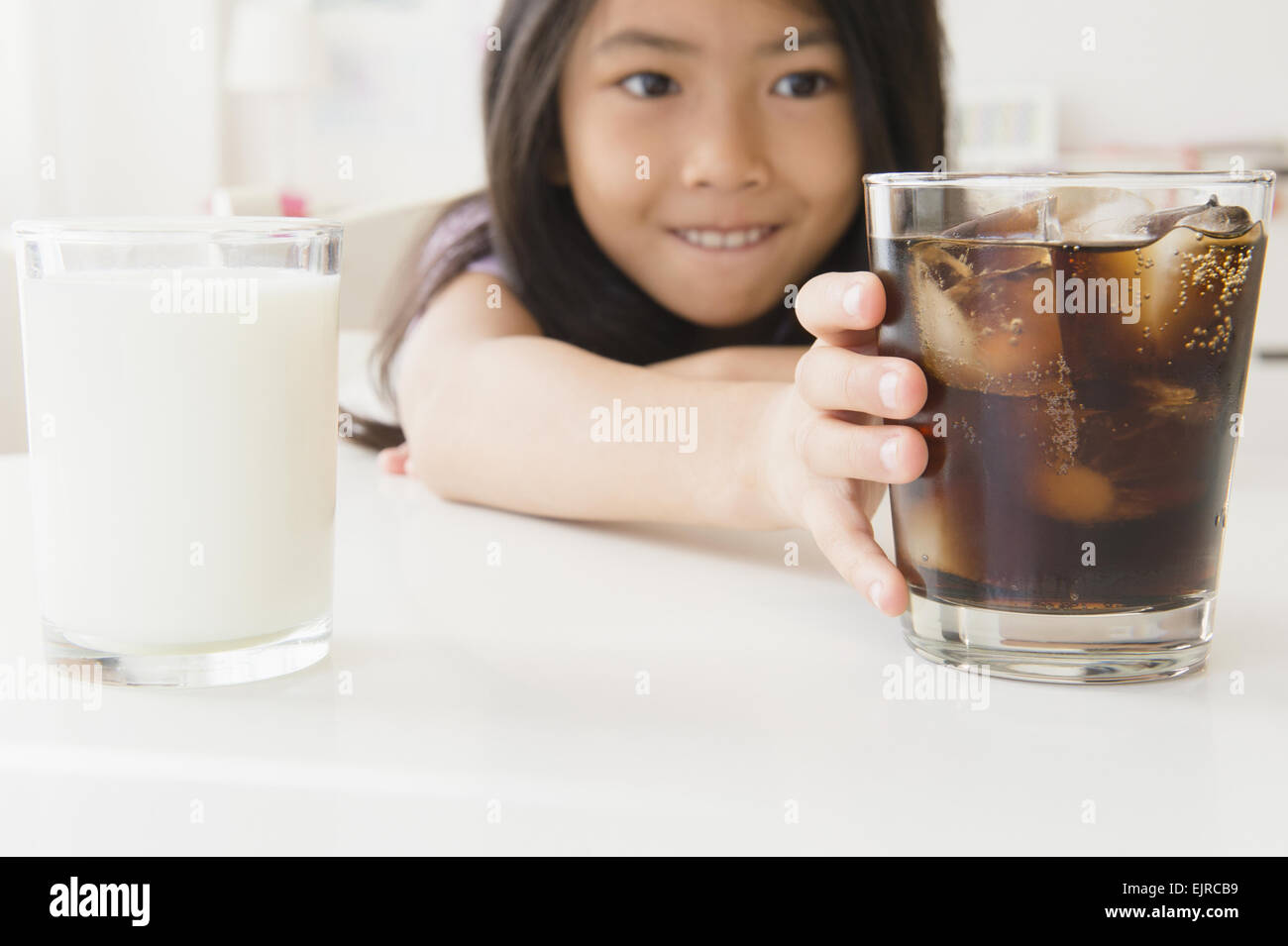 Vietnamese girl choosing glass of soda Stock Photo