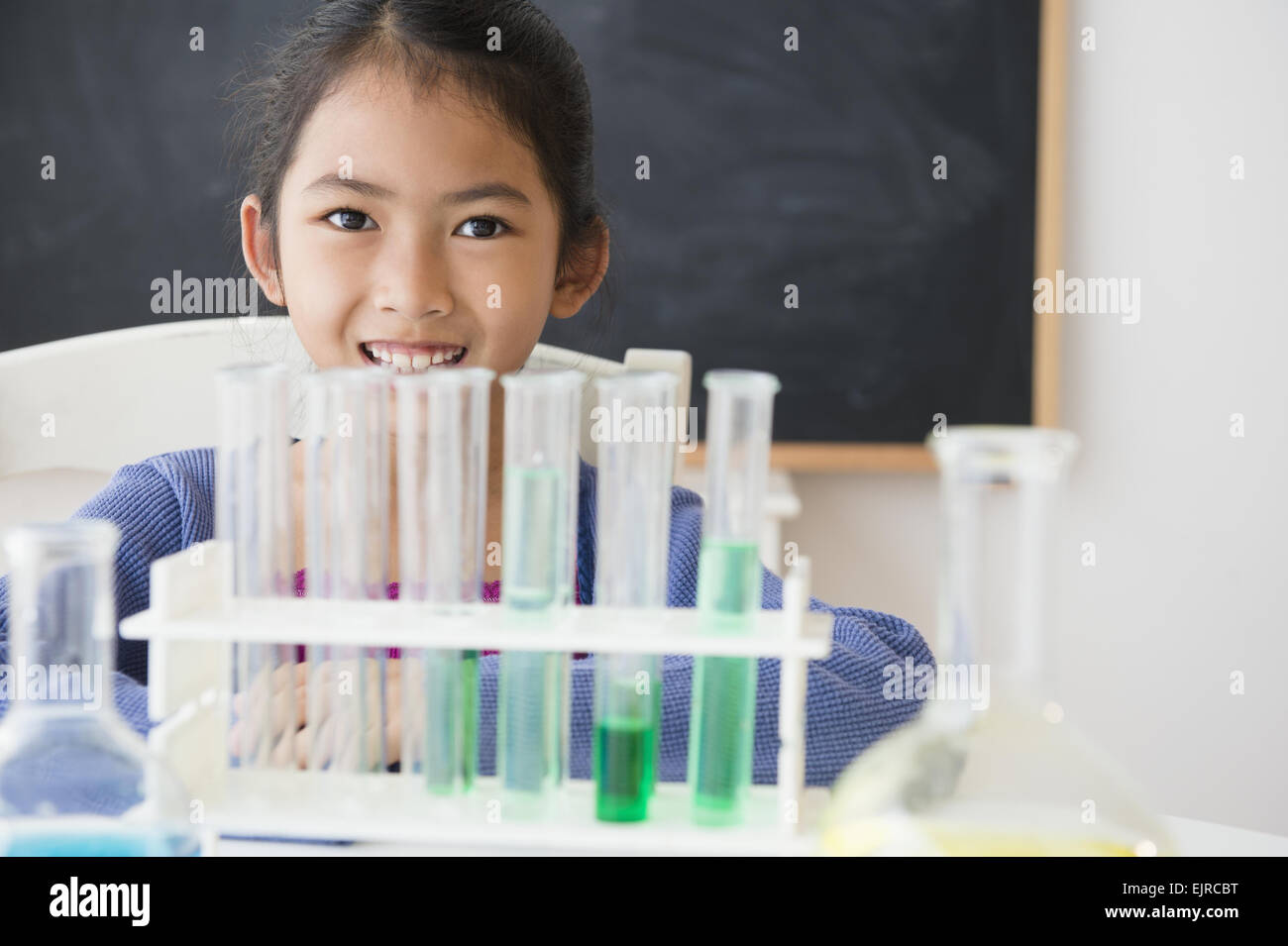 Vietnamese student doing science experiment in classroom Stock Photo