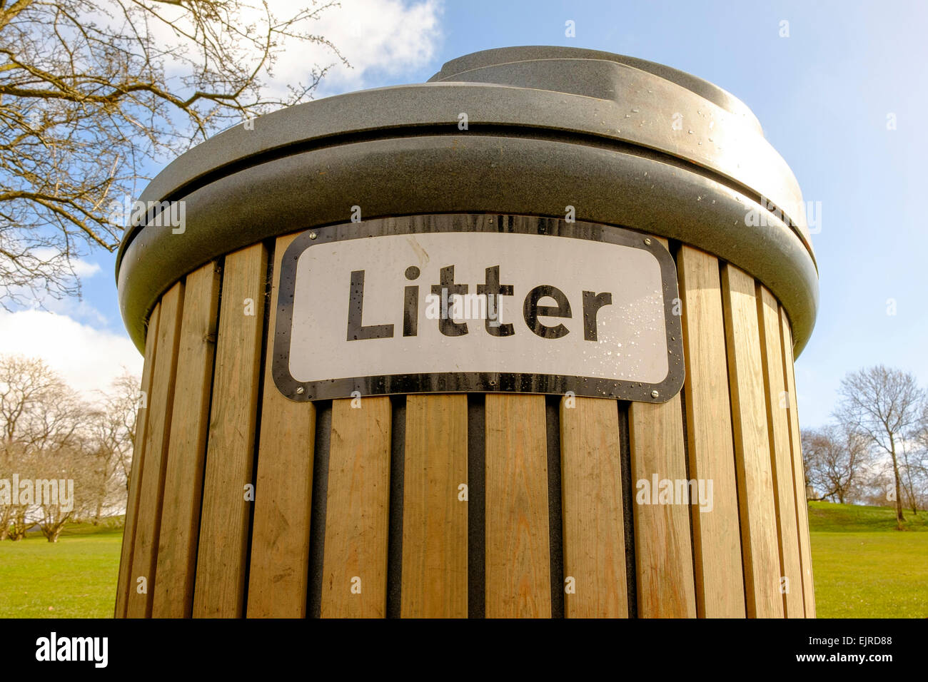 A large wooden Litter bin with plastic lid in Kelvingrove Park, Glasgow, Scotland, UK Stock Photo