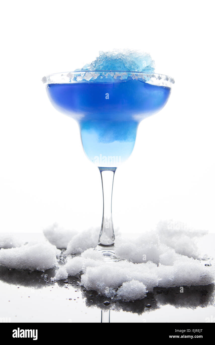 A margarita glass is filled with a blue frozen margarita; white sugar coats the rim Stock Photo