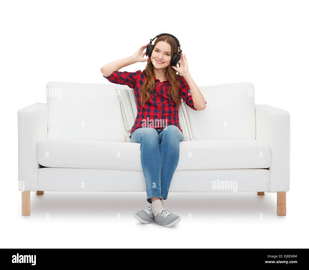 teenage girl sitting on sofa with headphones Stock Photo - Alamy