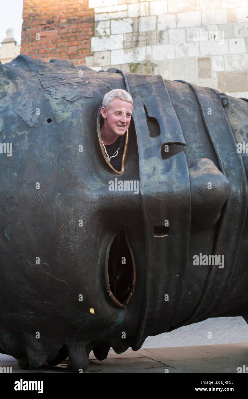 Looking out of giant head sculpture at Market Square, Krakow, Poland in