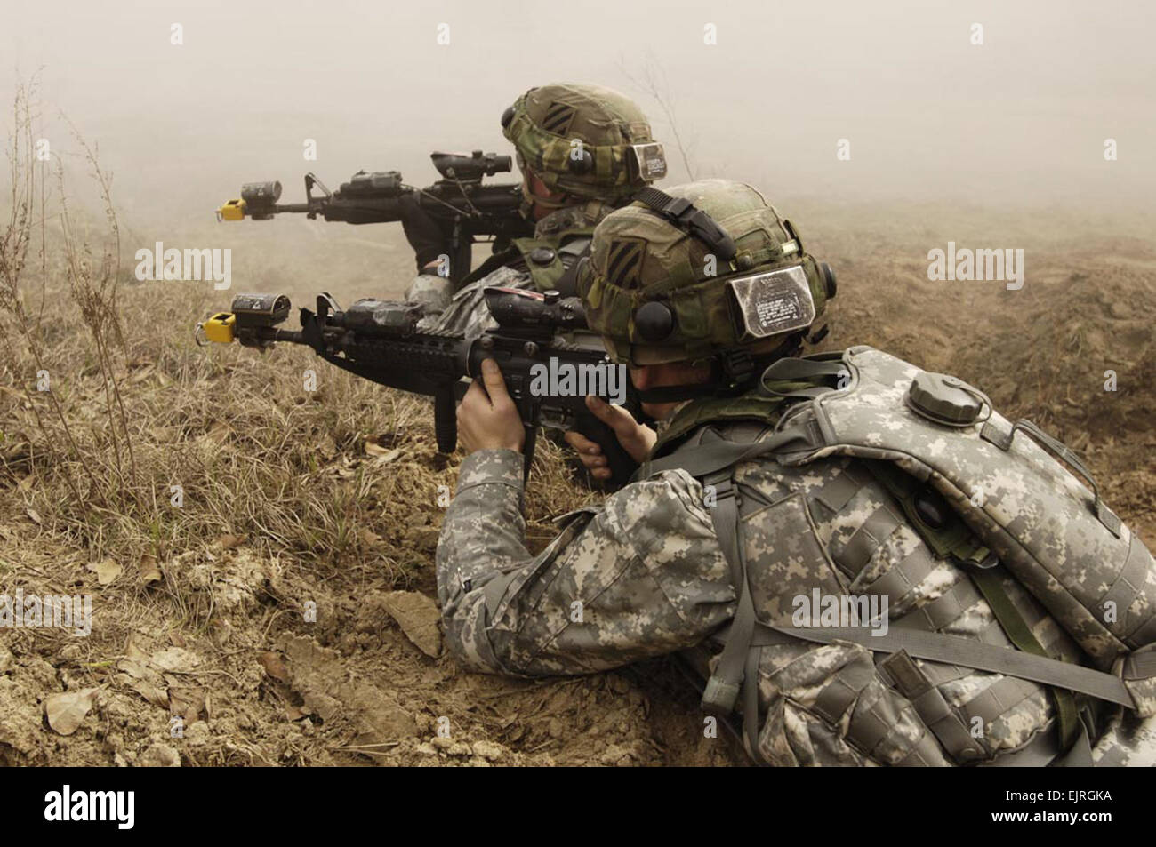 U.S. Army Soldiers from 1st Battalion, 64th Armor Regiment, 2nd Brigade Combat Team, 3rd Infantry Division react to sniper fire in the mock town of Medina Wasl during training at Fort Stewart, Ga., March 3, 2007.  The 3rd ID is conducting training with the assistance from observer controller teams from the National Training Center in preparation for a future deployment.  Staff Sgt. Alfred Johnson Stock Photo