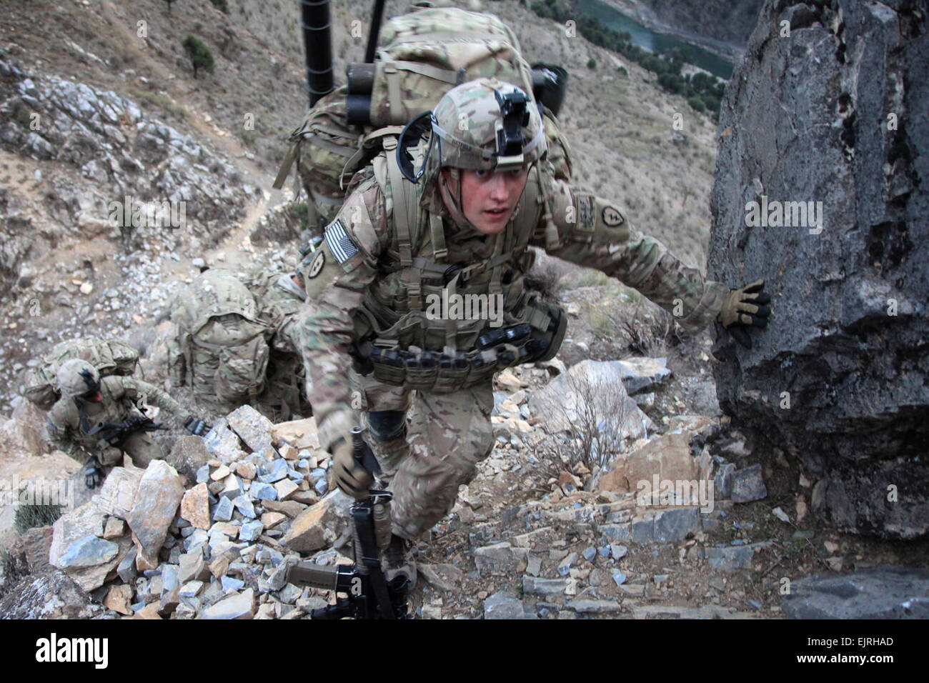 U.S. Army Spc. Daniel Hatfield, from 1st Platoon, Charlie Company, 2nd Battalion, 27th Infantry Division, Task Force No Fear, climbs a hill while conducting a patrol from Outpost Mace to Outpost Fawlad, during Operation Toufan Fawlad, in the Naray district, Kunar province, Nov. 17, 2011. U.S. soldiers of Charlie Company, 2nd Battalion, 27th Infantry Division, Task Force No Fear, are building watch positions to enable the ANSF to re-establish OP Fawlad. Stock Photo