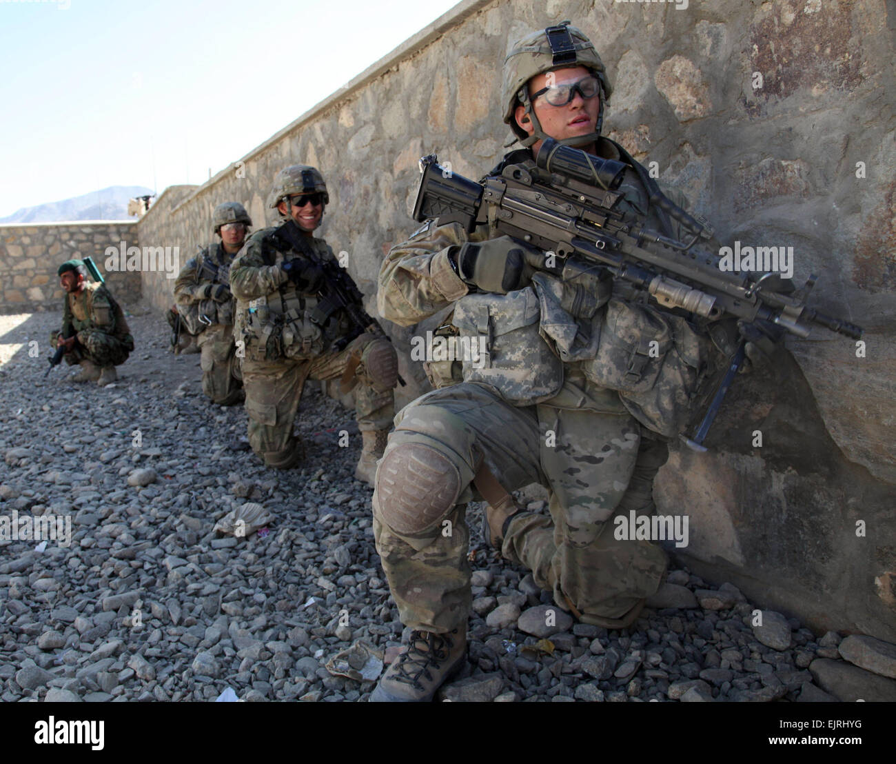 U.S. Army soldiers with Charlie Troop, 3rd Squadron, 89th Cavalry, 4th Infantry Brigade Combat Team, 10th Mountain Division wait for the order to move against enemy positions in Charkh, Logar province, Afghanistan, on Nov. 13, 2010.   Sgt. Sean P. Casey, U.S. Army.  Released Stock Photo