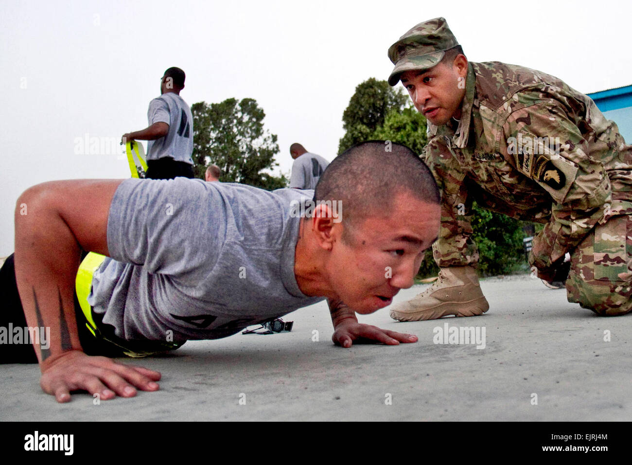 U.S. Army Sgt. 1st Class Jessie H. Sanchez with the 4th Brigade Combat Team “Currahee”, 101st Airborne Division Air Assault, observes a Soldier doing pushups, during an Army Physical Fitness Test for Currahees competing in Soldier/Non-commissioned Officer of the Quarter as well as the Sgt. Audie Murphy board at forward operating base Salerno, Afghanistan, July 14, 2013.  Sgt. Justin A. Moeller, 4th Brigade Combat Team Public Affairs Stock Photo