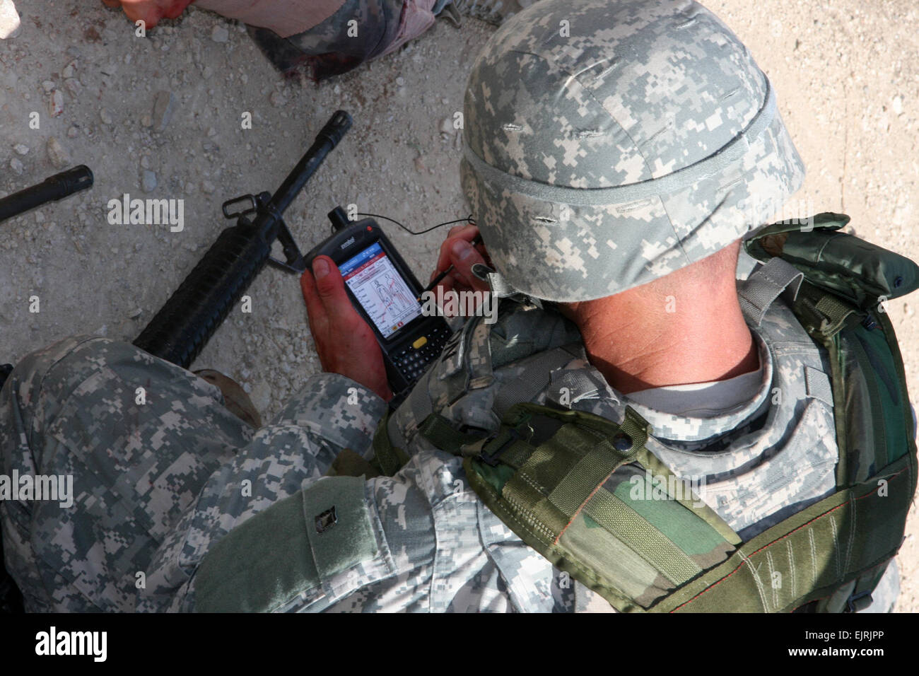An Army medic accesses medical records using the MC4 handheld device