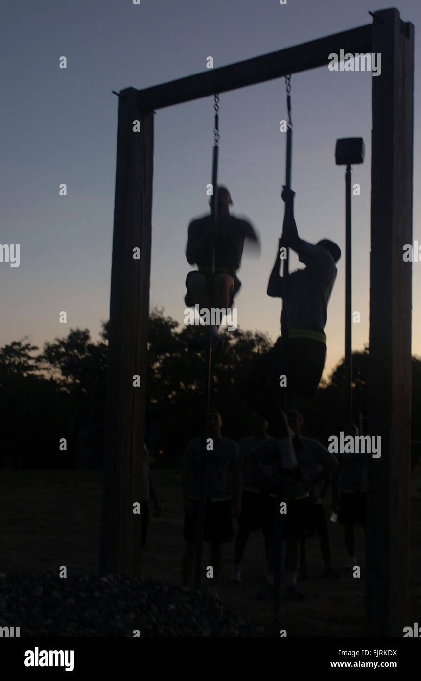 GUANTANAMO BAY, Cuba- Soldiers in Joint Task Force Guantanamoís 193rd Company, 525th Military Police Battalion, climb a rope during a regular physical fitness session, July 29, 2008. Soldiers in the 193rd meet five days a week for physical fitness training in an effort to stay in shape in U.S. Naval Station Guantanamo Bayís hot and humid climate. JTF Guantanamo conducts safe and humane care and custody of detained enemy combatants. The JTF conducts interrogation operations to collect strategic intelligence in support of the Global War on Terror and supports law enforcement and war crimes inves Stock Photo