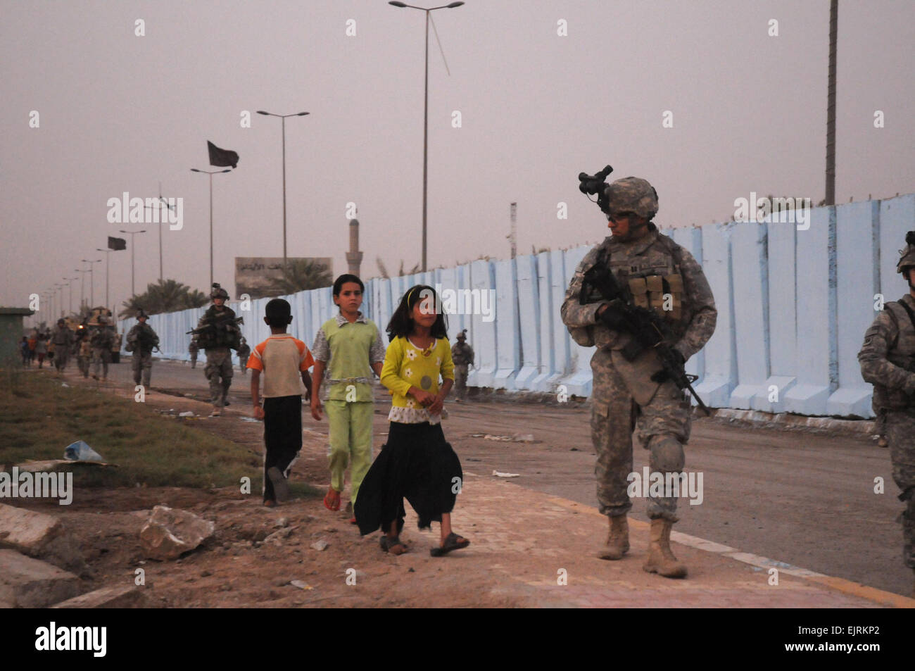 U.S. Army 432nd Civil Affairs Battalion Capt Jeovanny Rodriguez is followed by neighborhood Iraqi children while conducting a joint patrol with Task Force Regulars 1st Battalion, 6th Infantry Regiment, Renegade Company and Iraqi soldiers from the 11th Iraqi Army Division, 42nd Brigade through Thawra 2 and Jameela Market areas in the Sadr City district of Baghdad on Aug. 13, 2008.  Tech. Sgt. Cohen A. Young Stock Photo
