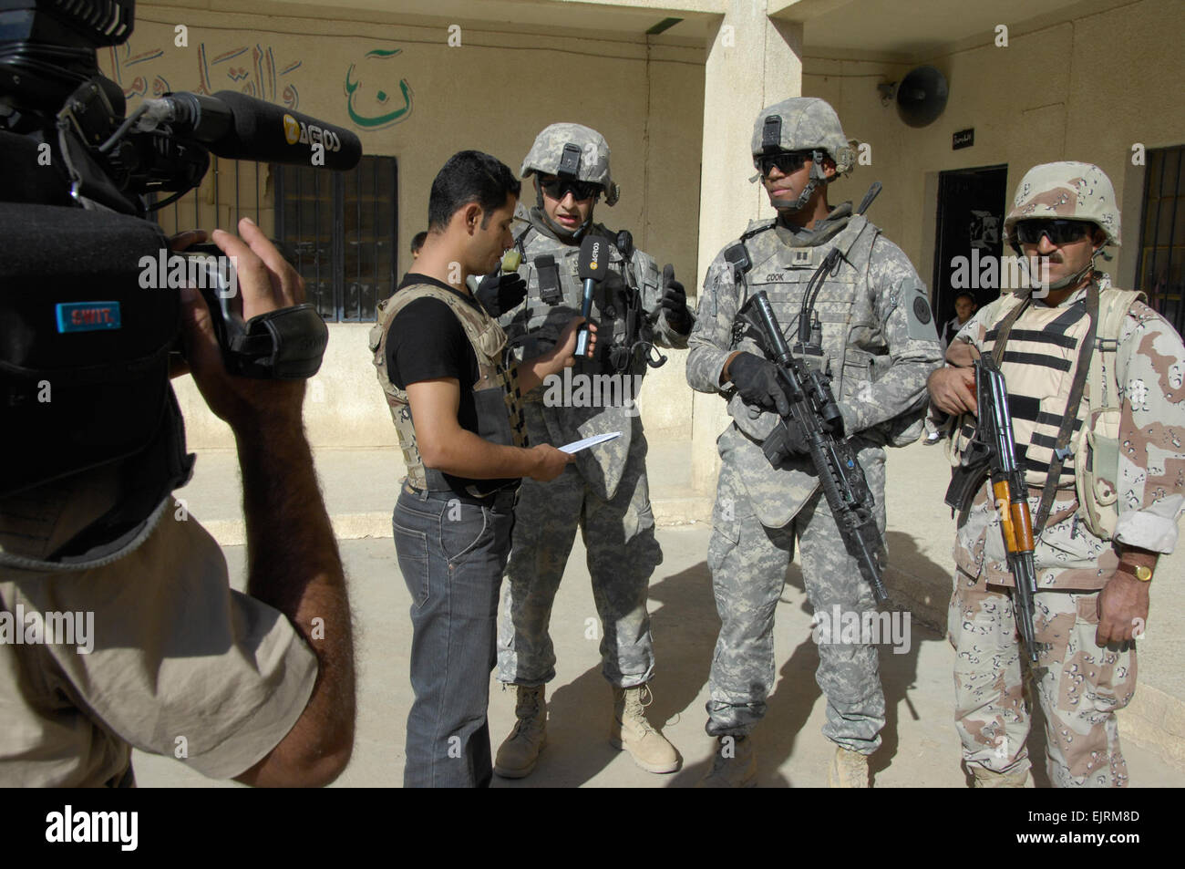 Iraqi reporters from Mosullia TV interview U.S. Army Capt. Kenneth Cook ...