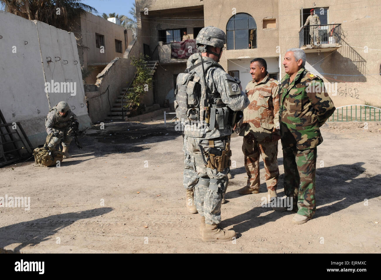 Iraqi army officers greet U.S. Soldiers of B Troop, 5th Cavalry, 73rd Regiment, 3rd Brigade Combat Team, 82nd Airborne Division, while linking up prior to conducting a dismounted patrol of Muhallahs 710 and 712, in Muthana Zayuna, eastern Baghdad, Iraq, on Jan. 2, 2009. Stock Photo