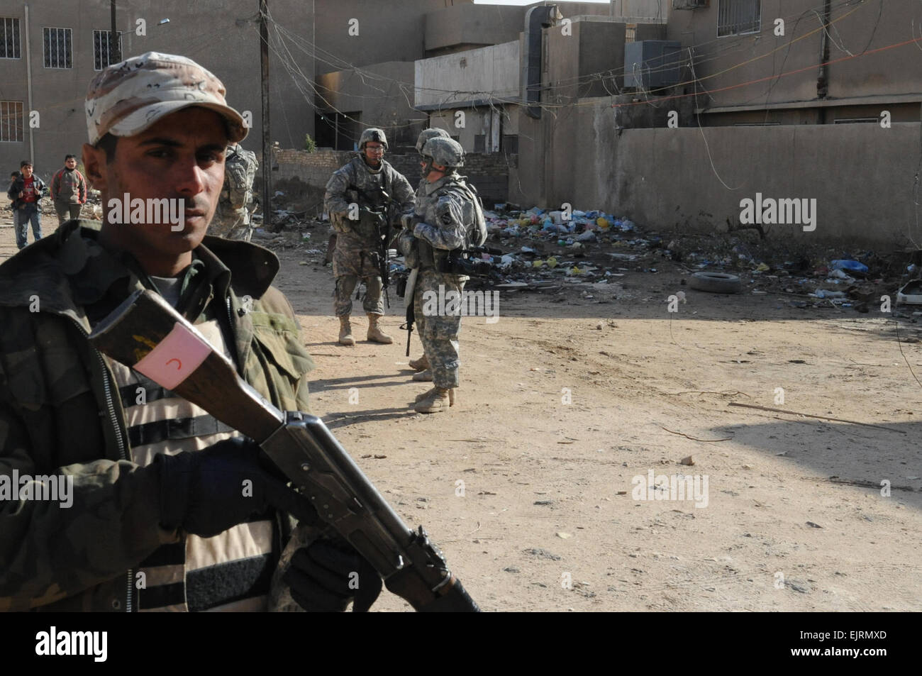 An Iraqi soldier provides security during a joint patrol with U.S. Soldiers of B Troop, 5th Cavalry, 73rd Regiment, 3rd Brigade Combat Team, 82nd Airborne Division, in Muhallah 710, Muthana Zayuna, eastern Baghdad, Iraq, on Jan. 2, 2009. Stock Photo