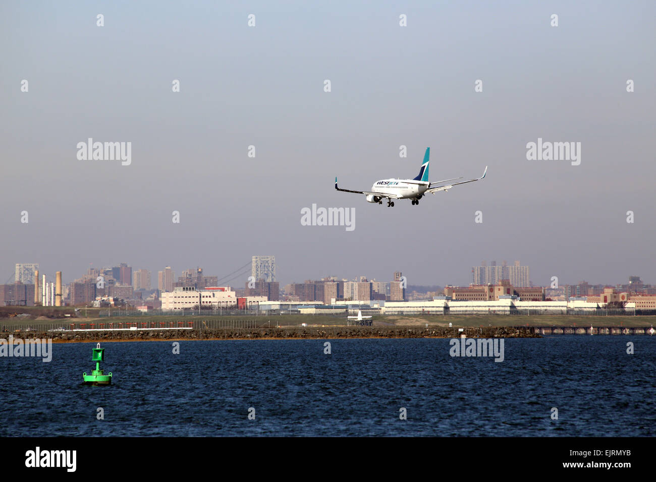 Jet on final approach to LaGuardia Airport, Queens, NY, USA Stock Photo