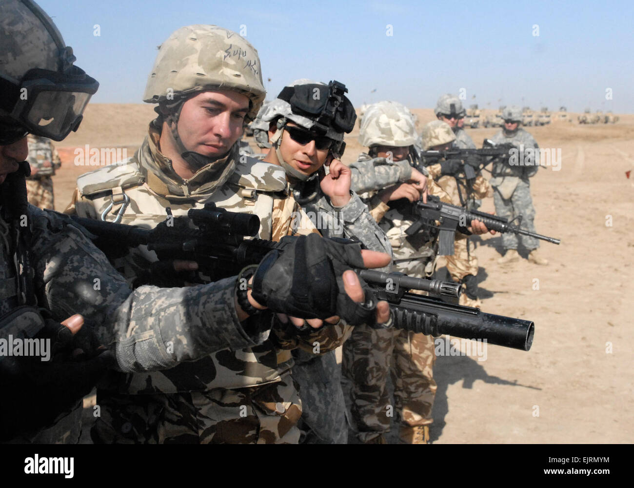 Soldiers of the 4th Brigade Combat Team, 1st Cavalry Division, demonstrate how to operate a M-4 carbine during a training exercise with troops from the 341st Romanian Infantry battalion during a cross-training event at the Bardia Firing Range near COB Adder, Iraq.  Pfc. Terence Ewings Stock Photo