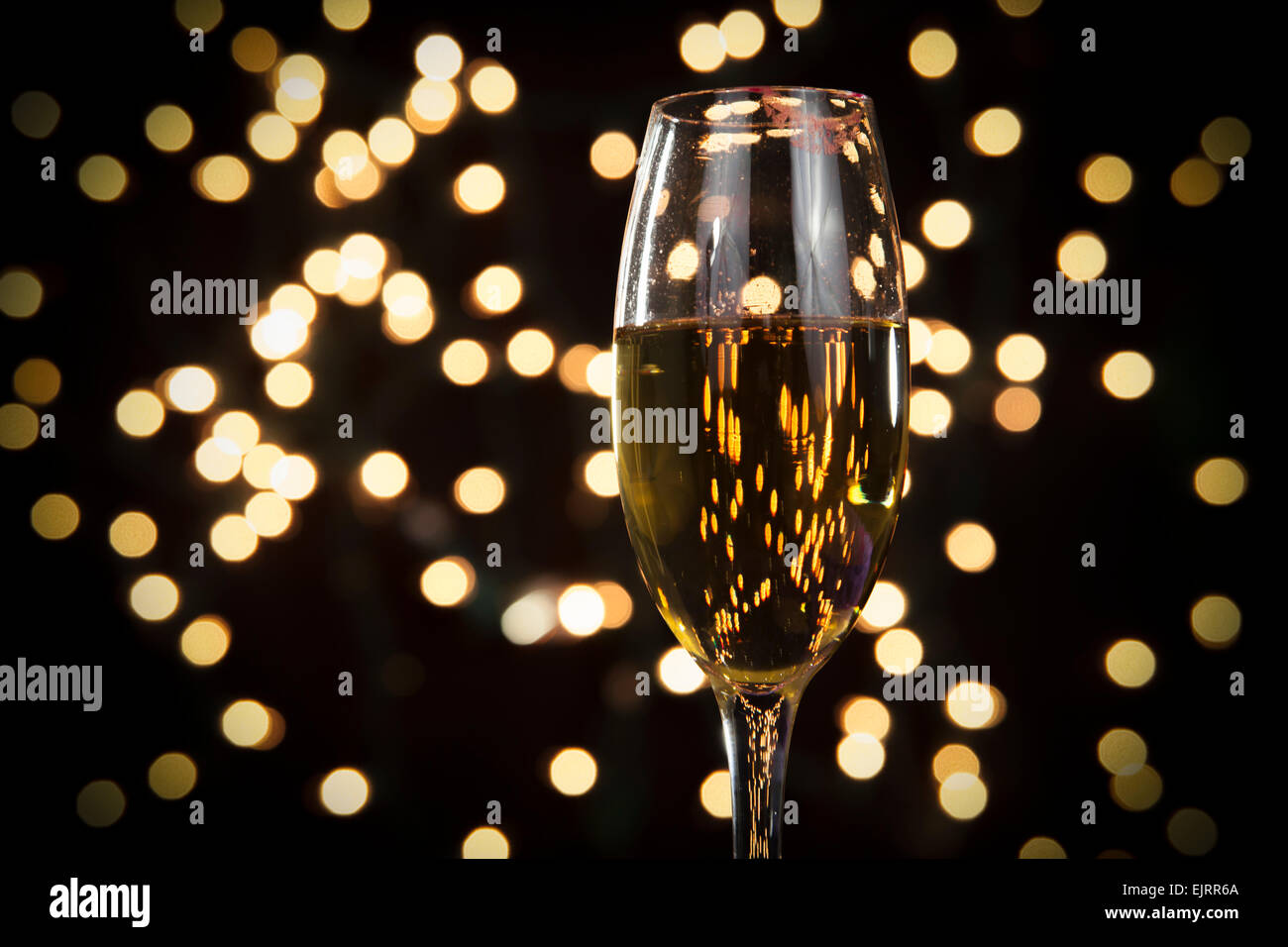 A champagne with a sparkle background;  white bokeh in background; perfect for Christmas and New Years; red lipstick marks stain Stock Photo