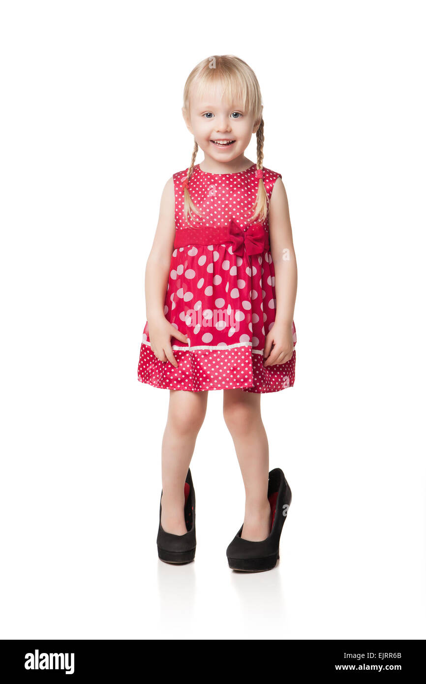 Smiling little girl wearing big shoes. Isolated on white background Stock Photo Alamy
