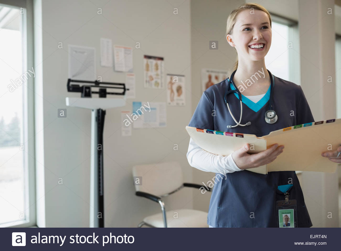 Nurses Medical Chart Smiling nurse looking medical chart hi-res stock photography and images ...