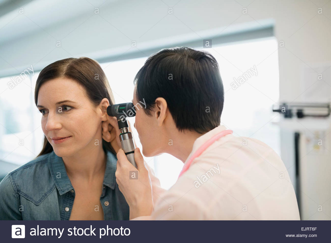 Doctor Checking Patients Ears With Otoscope Stock Photo Alamy