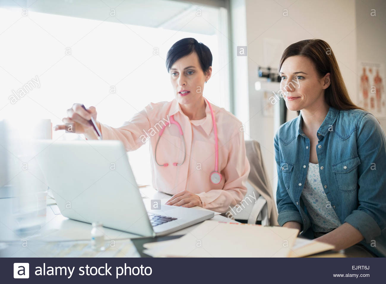 Doctor and patient in consultation at laptop Stock Photo
