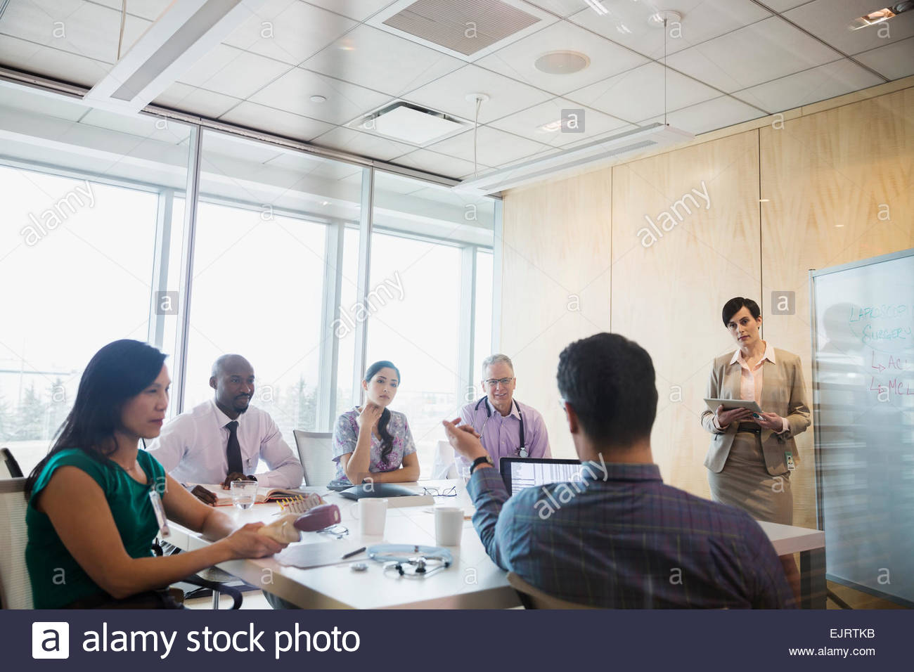 Administrator leading meeting in hospital conference room Stock Photo