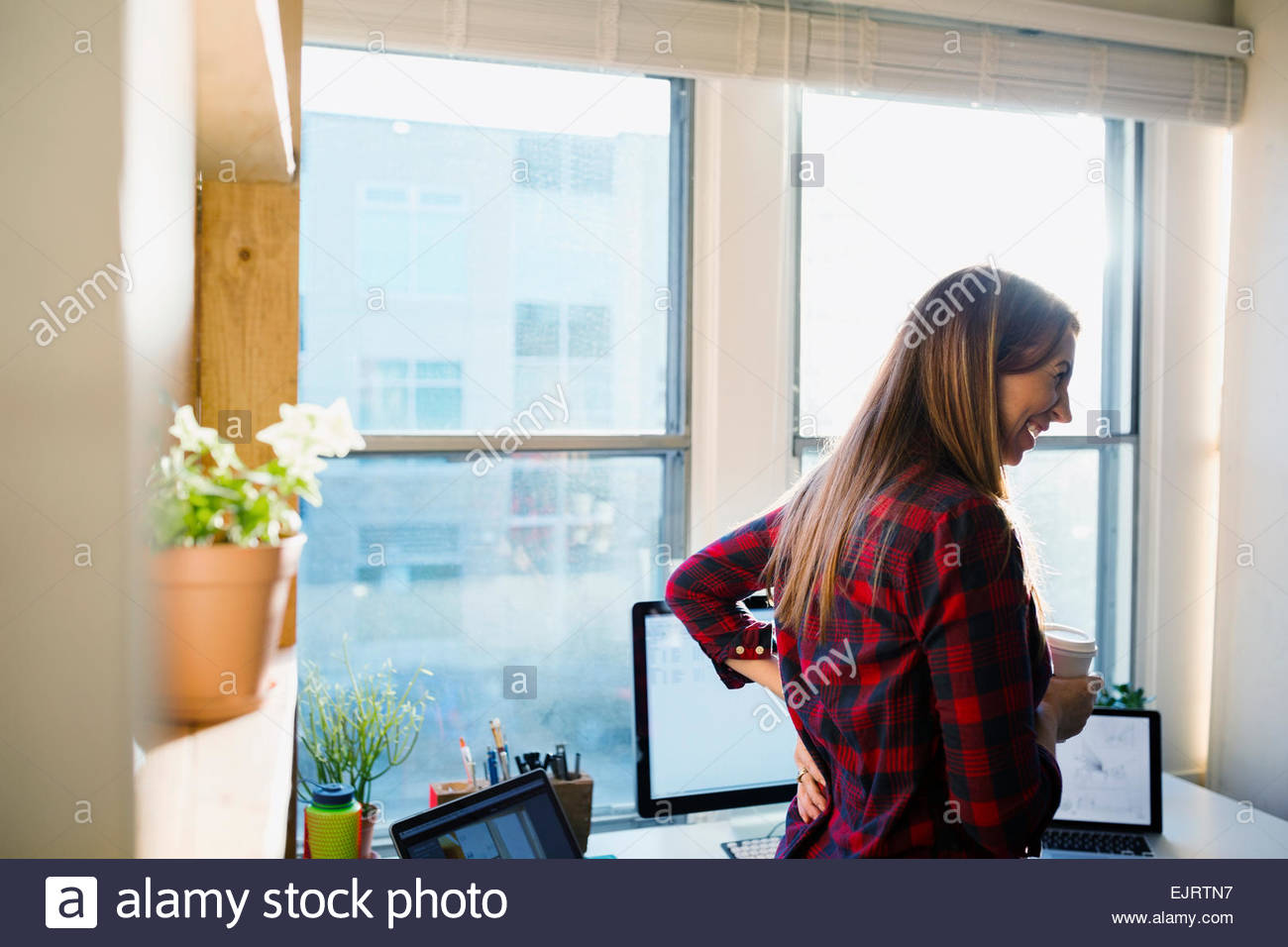 Designer laughing in office Stock Photo