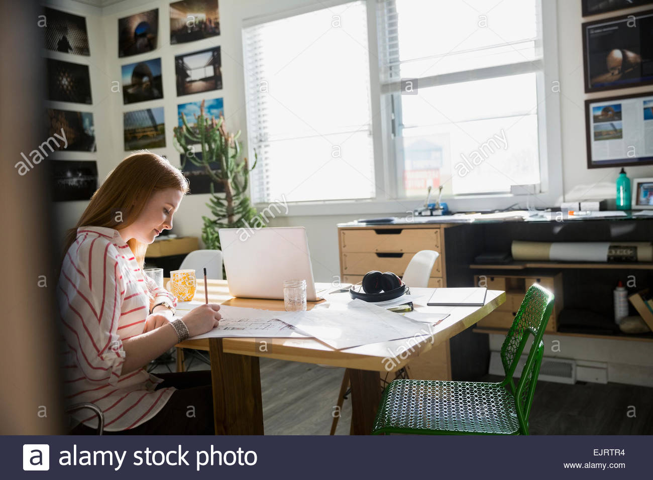Architect drafting blueprints in office Stock Photo