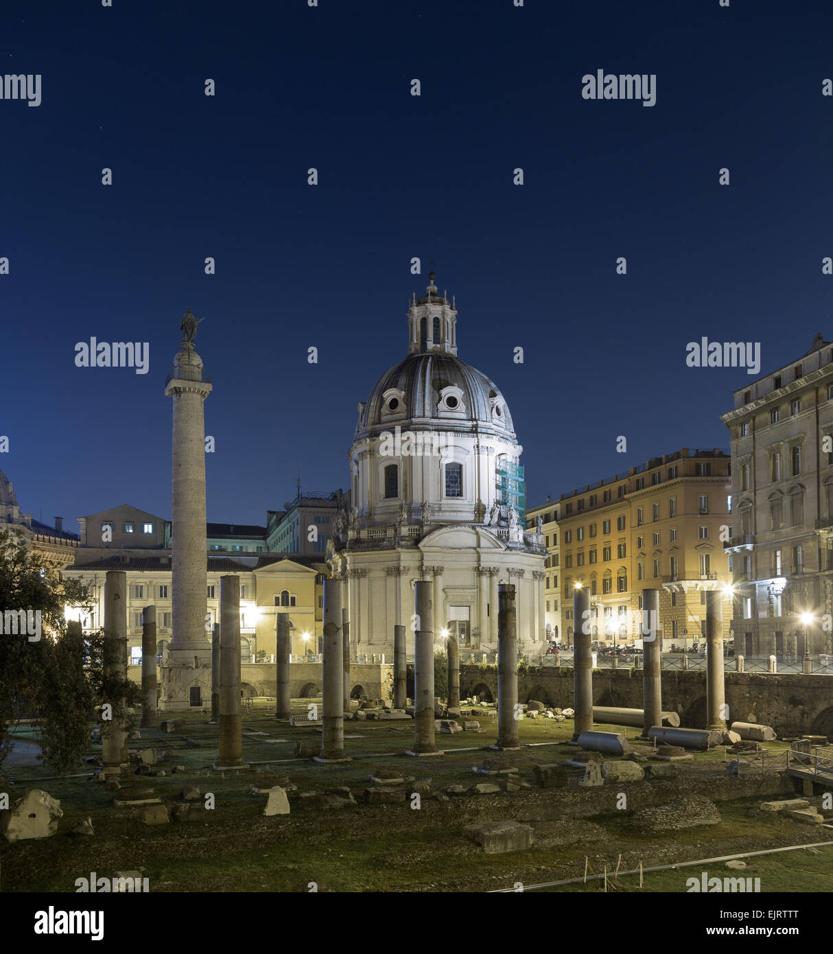 Part of the Trajan's Forum (Foro Di Traiano) at night showing some of the ruins, Trajan's Column and other buildings Stock Photo