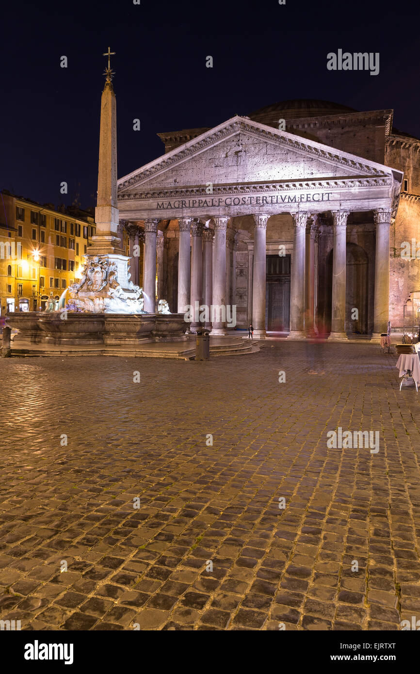 The outside of the Pantheon in Rome at Night. The blur of people can be seen outside Stock Photo