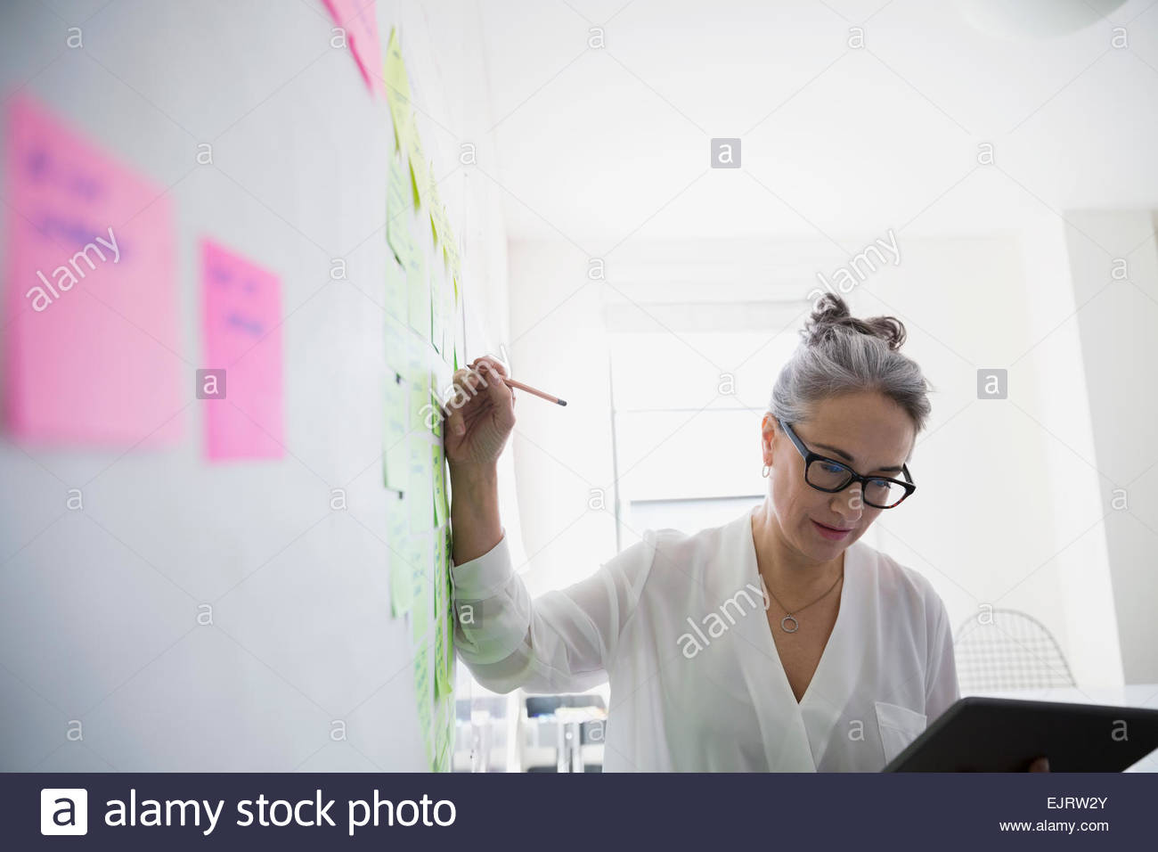 Businesswoman with digital tablet brainstorming Stock Photo